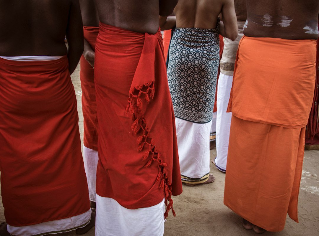 Men wearing traditional sarongs and white lower garments