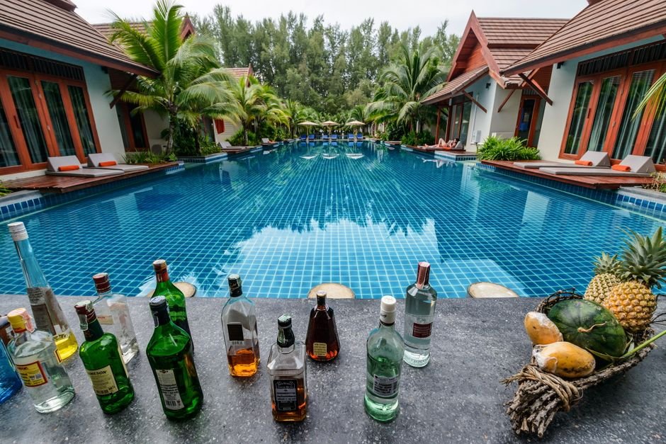 Relax by the resort pool with a tropical drink and enjoy the scenic view.