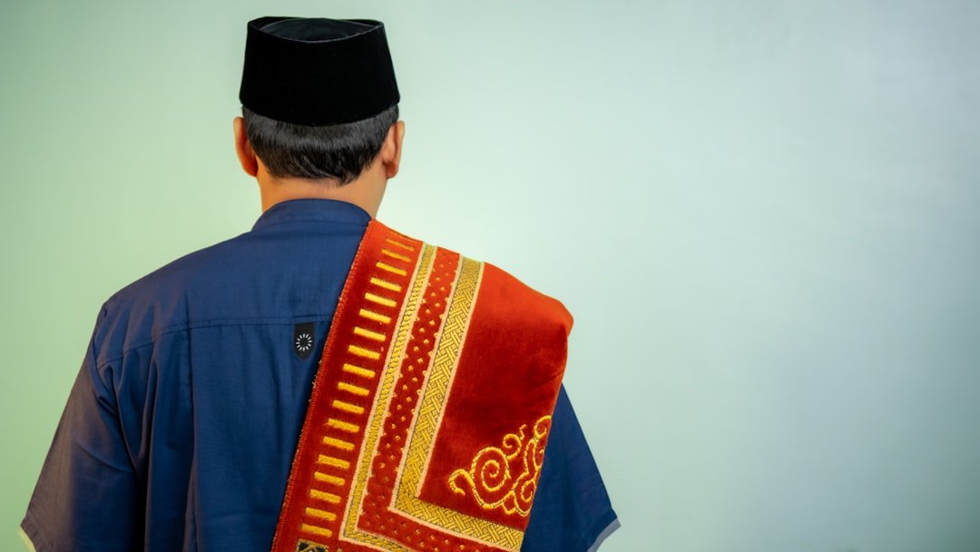 The look from behind of a muslim man with his sajdah on its shoulder.