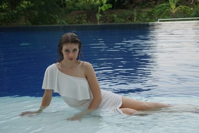 woman wearing a swim dress at the pool, best swim dress styles 2026