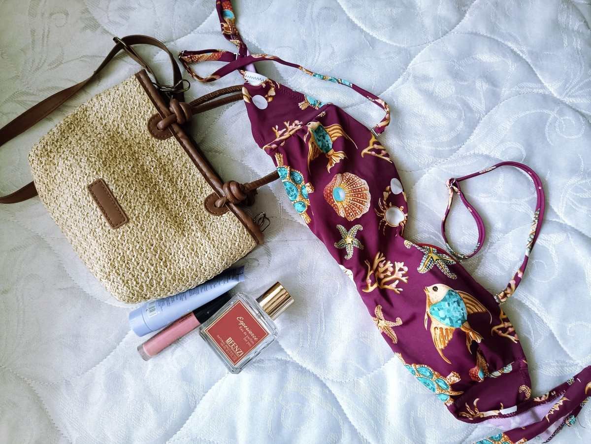 Swimwear subscription box flat lay with bikini and summer accessories