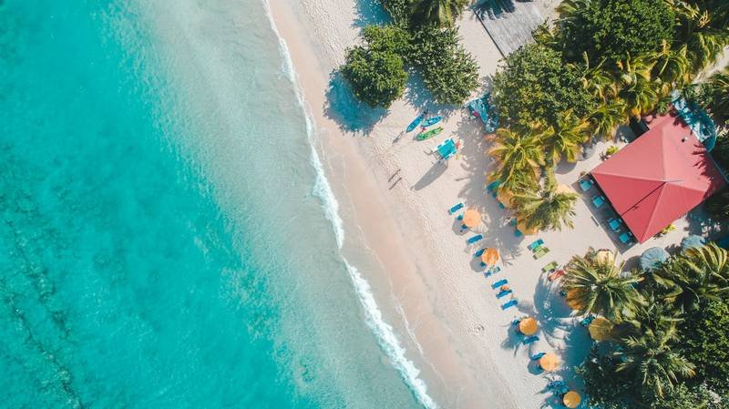 tropical beach destination near a protected coral reef requiring reef safe sunscreen