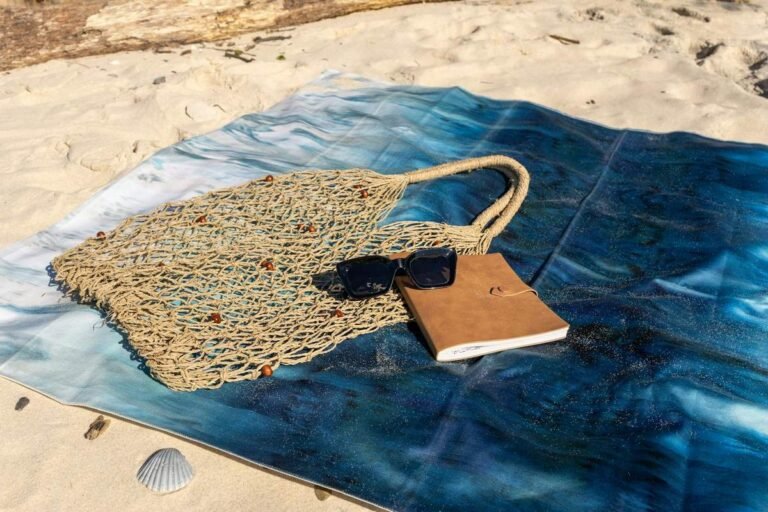 Beach bag essentials packed and ready on a sandy beach