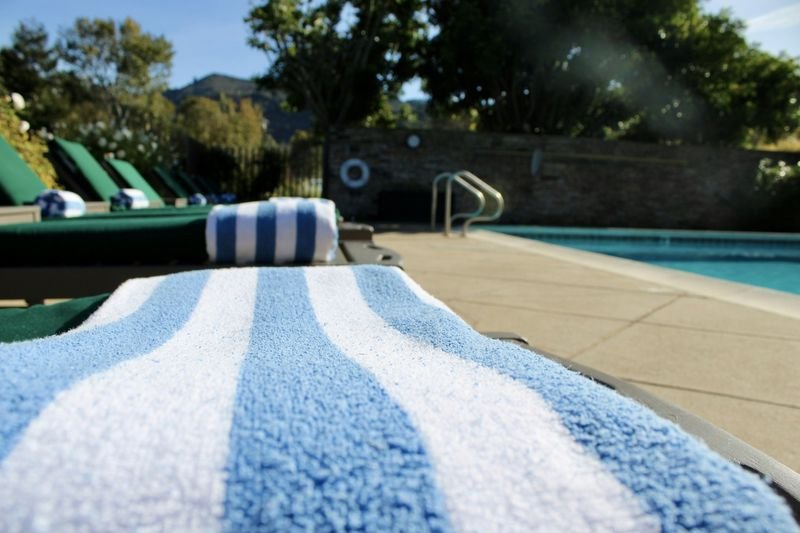 Neatly placed towel on a pool lounge chair showing tidy public pool etiquette