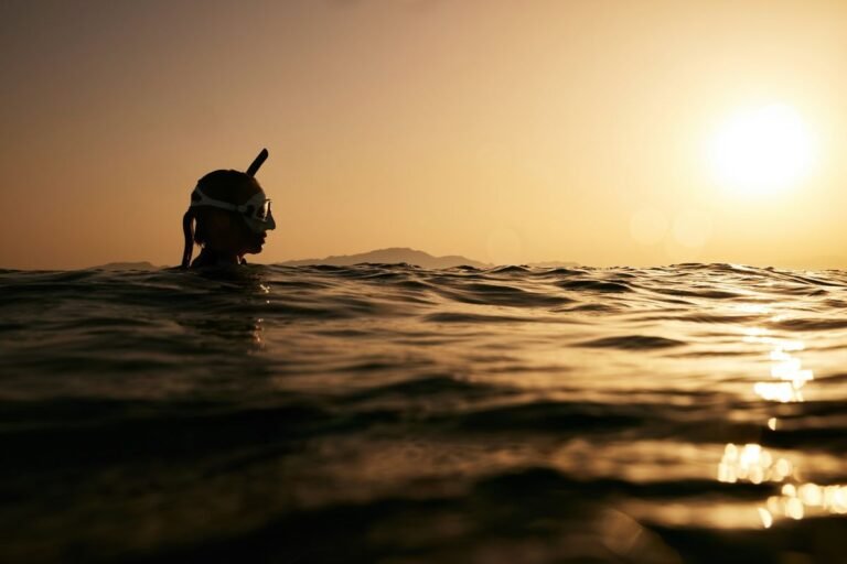 freediver swimming at sunset wearing secure freediving swimwear