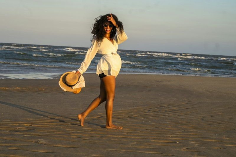 Woman holding a packable straw sun hat while traveling