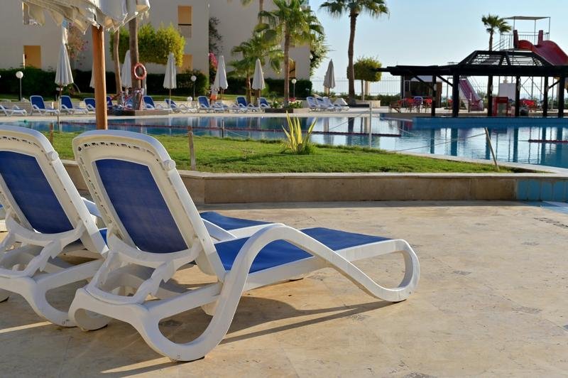 Rows of empty pool lounge chairs illustrating pool chair etiquette