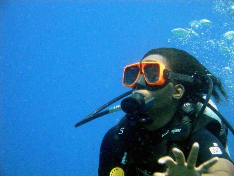 diver wearing scuba diving swimwear and mask in the water