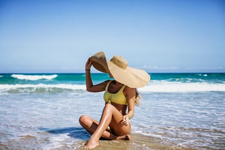 Woman wearing a wide-brim UPF sun hat at the beach