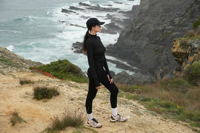 woman in UPF swim leggings for snorkeling overlooking the ocean