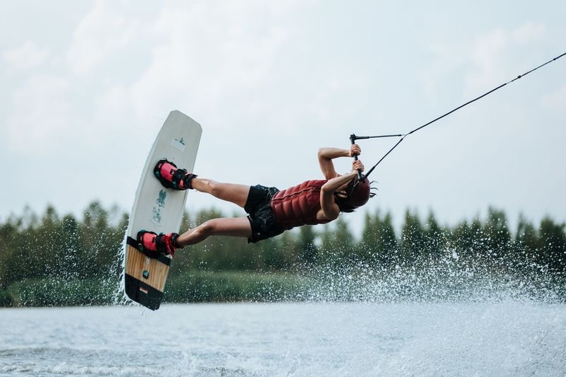 Wakeboarder performing an aerial trick in compression-fit wakeboarding swimwear