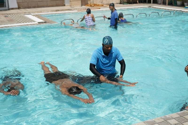 Water aerobics swimwear instructor leading pool class