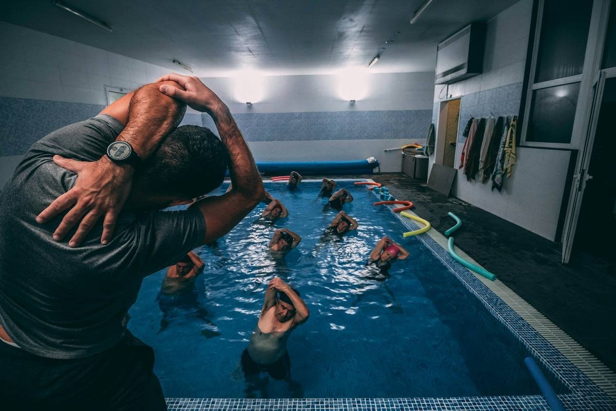 Woman stretching before a water aerobics swimwear class in the pool