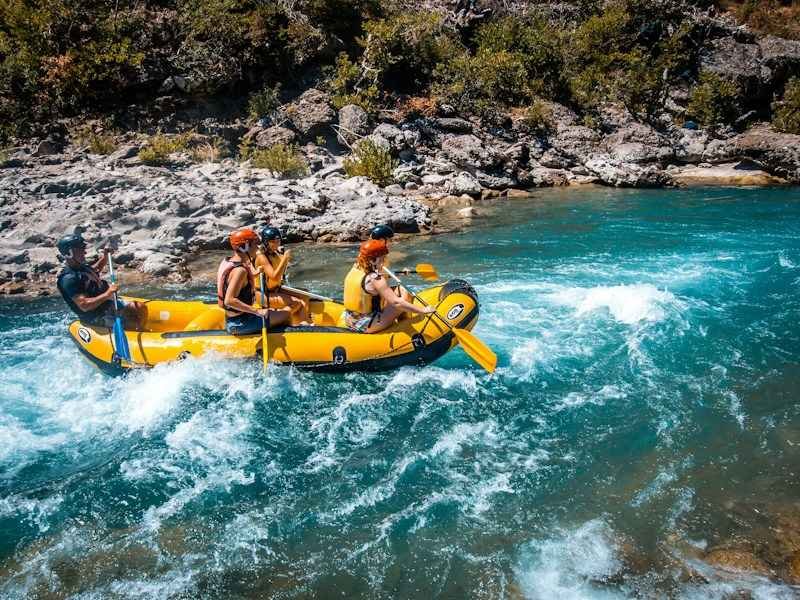 group wearing quick-dry rafting swimwear on a whitewater raft